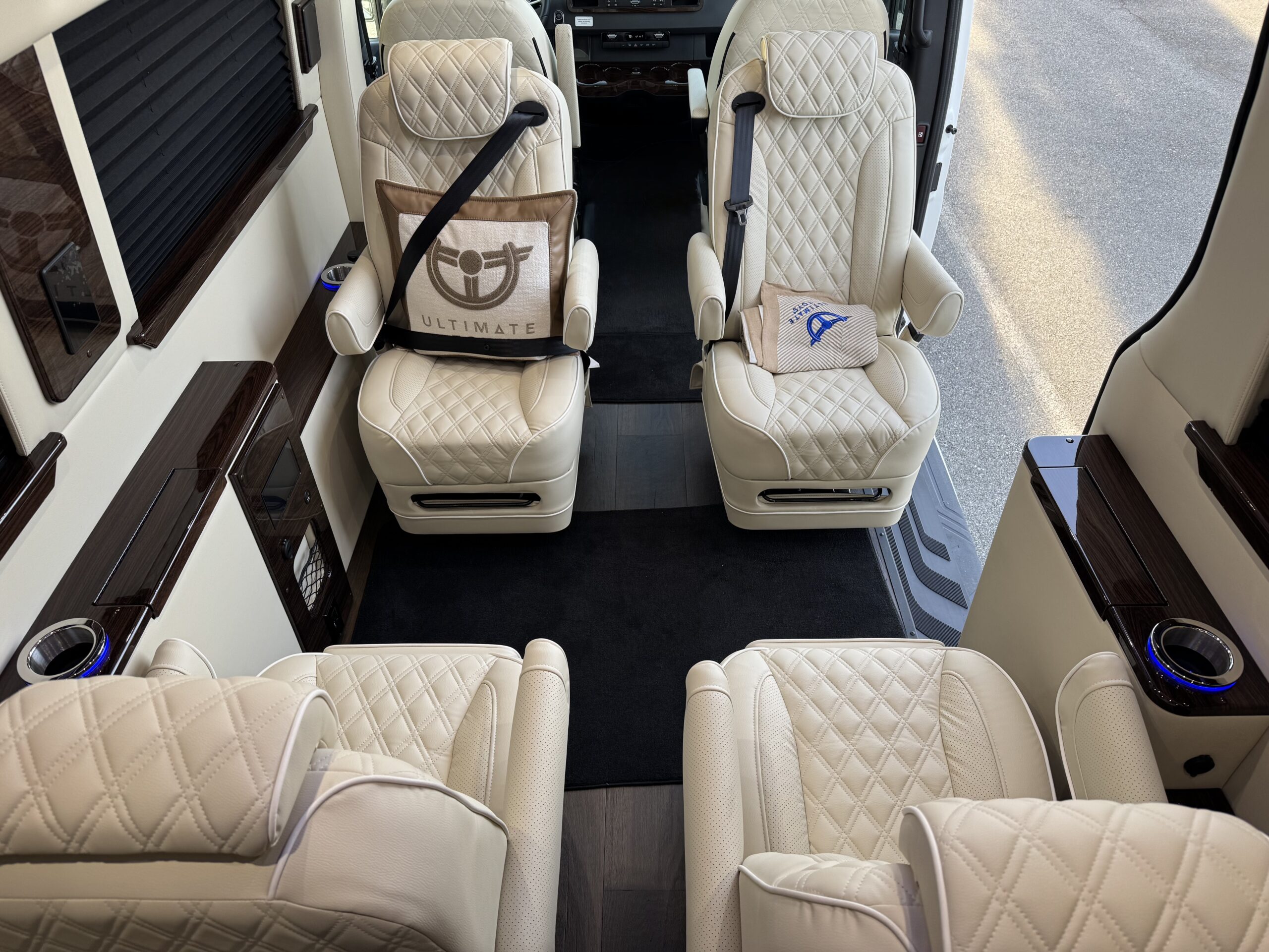 The interior of the luxury van with the seats repositioned to be facing one another.